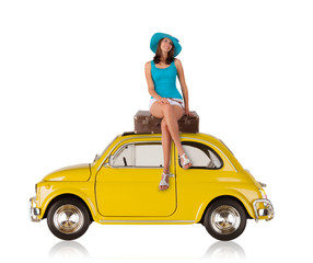 Beautiful young woman posing on old car, manufactured between year 1957 - 1975. Concept of summer travel. Isolated on white background - obrazy, fototapety, plakaty