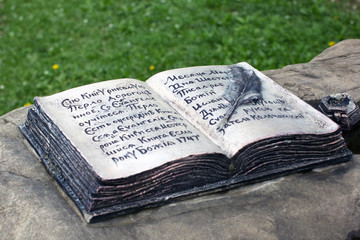 Fototapeta premium Bronze open book with pen and ink as a monument