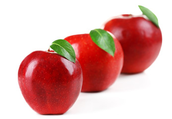 Red apples with leaves isolate on white