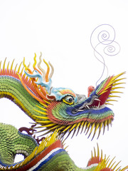 a colorful chinese dragon on white background, the dragon have green and yellow flakes with red and yellow fins. the dragon long mustaches point up.