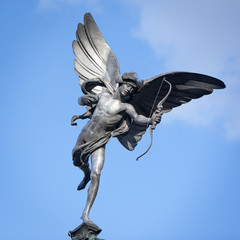 Statue of Eros, Piccadilly Circus, London. A low angle view of the familiar statue of Eros in Piccadilly Circus, London. - obrazy, fototapety, plakaty