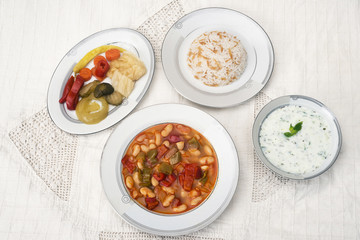 Turkish traditional meal, beans, rice, mixed pickles and tzatziki