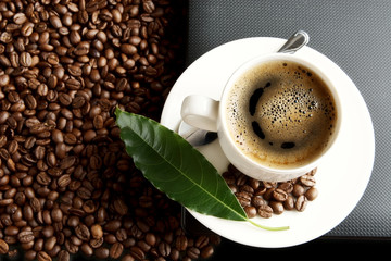 Brewed coffee on the laptop with coffee leaf at office