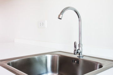 Water tap and sink in a modern kitchen.