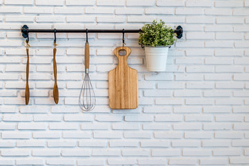 kitchenware on white brick background