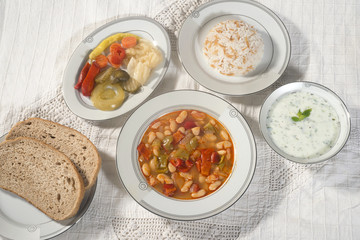 Turkish traditional meal, beans, rice, mixed pickles and tzatziki