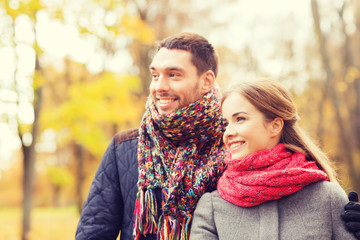 Fototapeta premium smiling couple hugging on bridge in autumn park