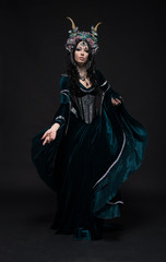 Beautiful fantasy elf woman in flower crown and medieval dress