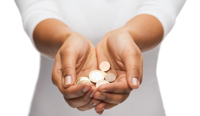 womans cupped hands showing euro coins