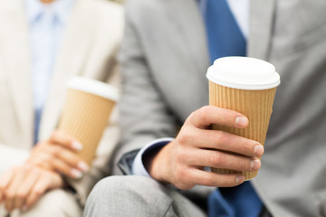 close up of business people hands with coffee cups