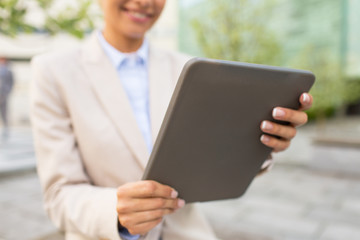 close up of business woman with tablet pc in city