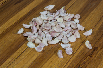 Garlic heap on the wooden floor.