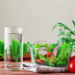 Vegetable salad with a glass of pure water