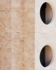 fenêtres circulaires sur façade en marbre