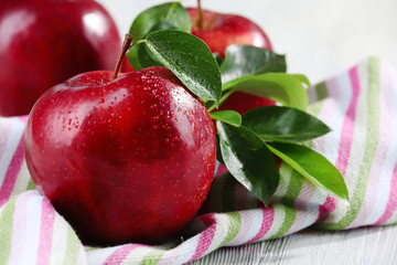 Ripe red apples on table close up