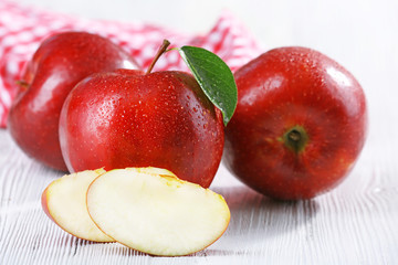 Ripe red apples on table close up