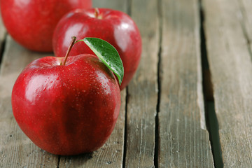 Ripe red apples on table close up