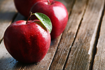 Ripe red apples on table close up
