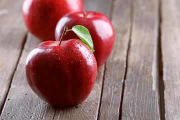 Ripe red apples on table close up