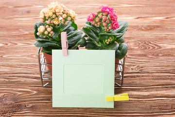 card and flowers on a wooden background