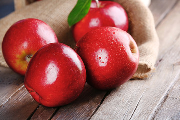 Ripe red apples on table close up