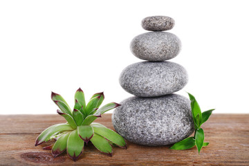 Obraz na płótnie Canvas Spa stones with succulent on wooden table isolated on white