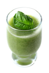 Glass of green healthy juice with basil isolated on white