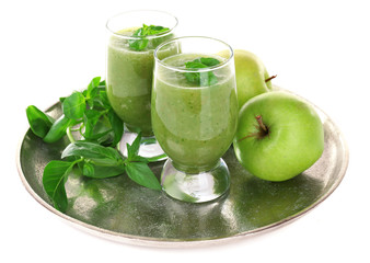 Glasses of green healthy juice with basil and apple isolated on white