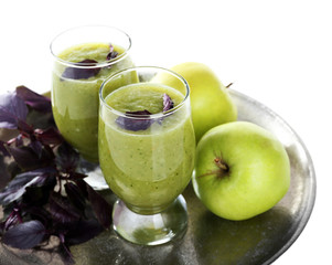 Fototapeta na wymiar Glasses of green healthy juice with basil and apple isolated on white