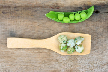 Fresh green soybeans and coated nuts on wood vintage