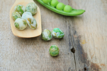 Fresh green soybeans and coated nuts on wood vintage