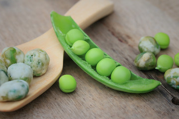 Fresh green soybeans and coated nuts on wood vintage