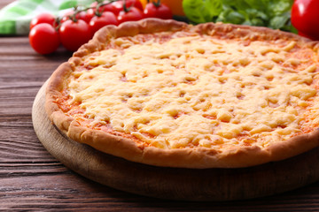 Cheese pizza with vegetables on table close up