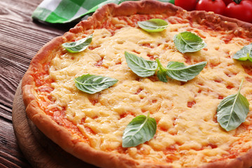 Cheese pizza with cherry tomatoes on table close up