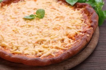 Cheese pizza with basil on table close up