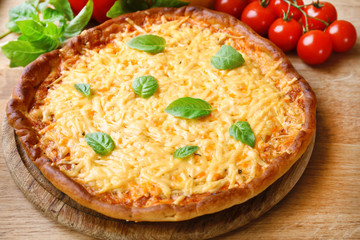 Cheese pizza with cherry tomatoes on table close up