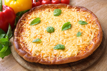 Cheese pizza with vegetables on table close up