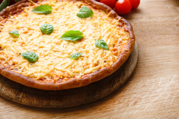 Cheese pizza with cherry tomatoes on table close up