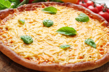 Cheese pizza with vegetables on table close up