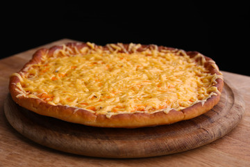 Tasty cheese pizza on black background