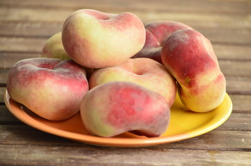 flat peaches lie on a plate