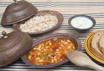 Turkish traditional meal, beans, rice, mixed pickles and tzatziki