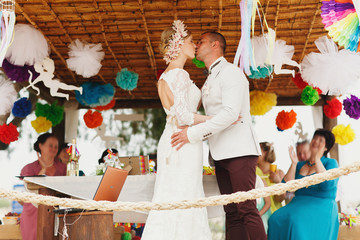 beautiful  gorgeous blonde bride  and stylish groom, hawai  colorful sand ceremony  on cyprus