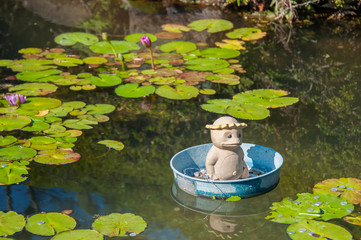 kappa statue in the bucket on the pond.