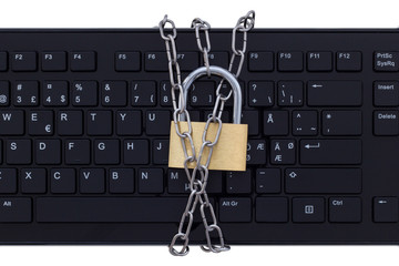 Fototapeta premium Keyboard protected by metal chain and a lock, isolated on white background. Concept photo of Internet and computer security and safety.