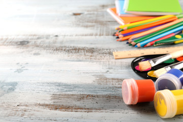 Colorful school stationery on wooden background