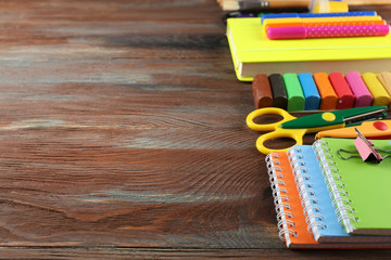 Colorful school stationery on wooden background