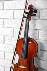 Fototapeta na wymiar Violin on bricks wall background