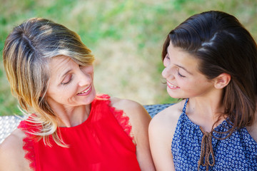 Mother and daughter hugging, smiling and sharing. Mothers day concept. Serenity and tranquility.