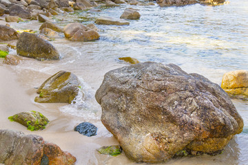 Big rocks on a smooth sand Mediterranean beach